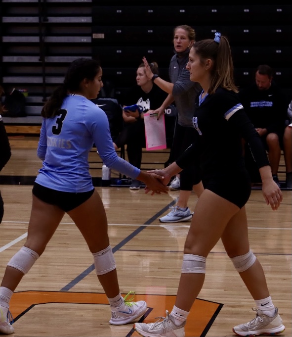 Libero Mayte Camacho and outside hitter Hope Lusher celebrate after a play. The team lost 3-0 to Oviedo.