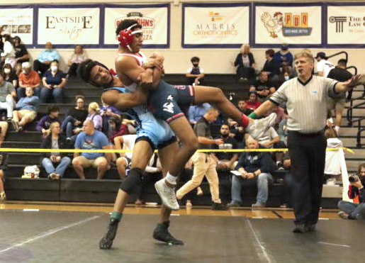 Senior David Mejia is lifting his opponent in the air because he is trying to return him to the mat. Mejia won this match by pin. 