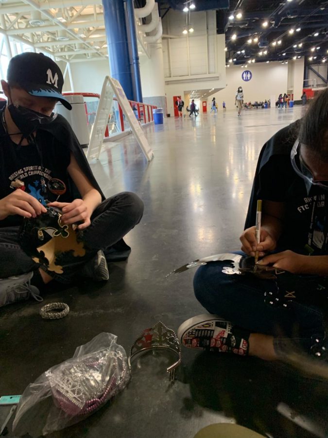 The members of 4717 work on their paper crowns for Tiara Day at worlds. The team was able to still have some fun with dress-up days at worlds, with Tiara Day and Suspender Saturday.