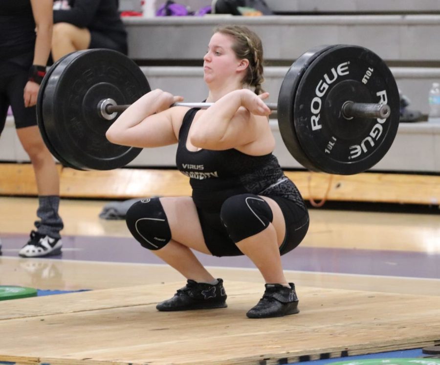 Senior Chloe Varady is in the bottom of her clean and jerk of 155 lbs at the district championships. Varady placed first at districts, granting her a spot at regionals and soon competed at states where she placed fifth.