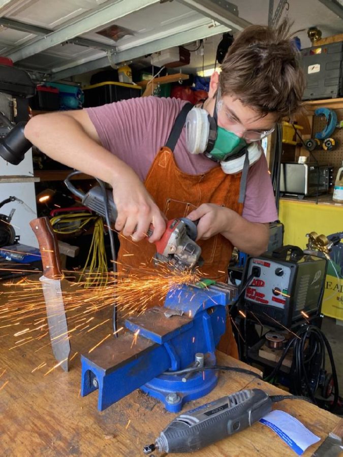 Freshman Callan OConnor uses a grinder on a metalworking project. He has been into blacksmithing for nearly two years.