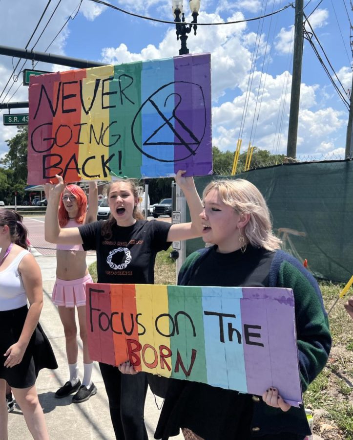 Winter Springs sophomore Amy Brewster and Oviedo sophomore Ella Pilacek chant My body, my choice at the Tuskawilla protest. Brewster organized this protest following the leak of a Supreme Court draft opinion that suggests the overturn of Roe v. Wade.
