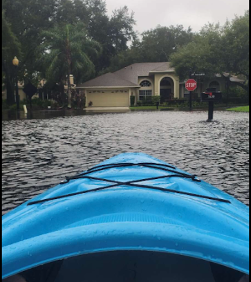 Junior Preston Rupert floats on a kayak across a flooded street in Twin Rivers. Though Hurricane Ian passed through his neighborhood on Wednesday and Thursday, the flooding did not reach its peak until Friday morning. 