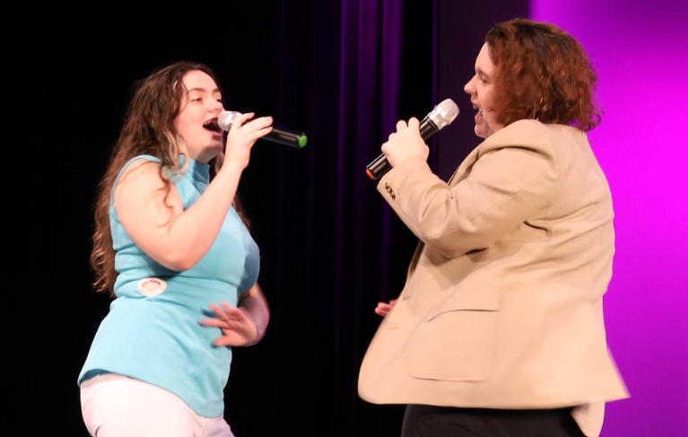 Singing a duet of “Love Shack, senior Mac Anderson and sophomore Megan Anderson perform in the chorus pop concert on Oct. 11. The event consisted of 20 acts and lasted one and a half hours.