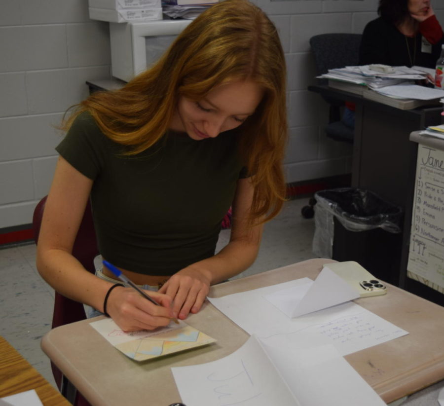 President Julia Bochkarev finishes up her card by writing her poem to go along with her drawing. The Poet society meets one Friday a month after school in room 3-211B. 
