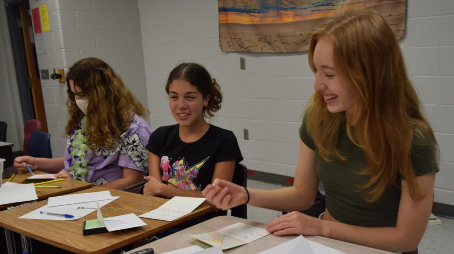Poet Society members Julia Bochkarev, Kylie Gaetan and Ivy Thompson, discuss their poems and drawings with one another. Poet Society 