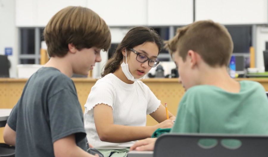 First Lego League Dino Nuggies team member Aubrey Belcher sketches a rough plan for a robot with her team members. In total, there are four girls in the middle school robotics program.