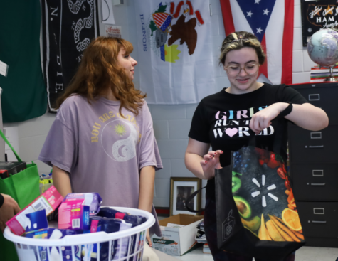 Compton and sophomore Megan Anderson empty feminine hygiene products into Girl Up’s donation bin. Girl Up’s next meeting will be in mid-March for members to get their stickers to sell and prepare to sell stickers at lunch.