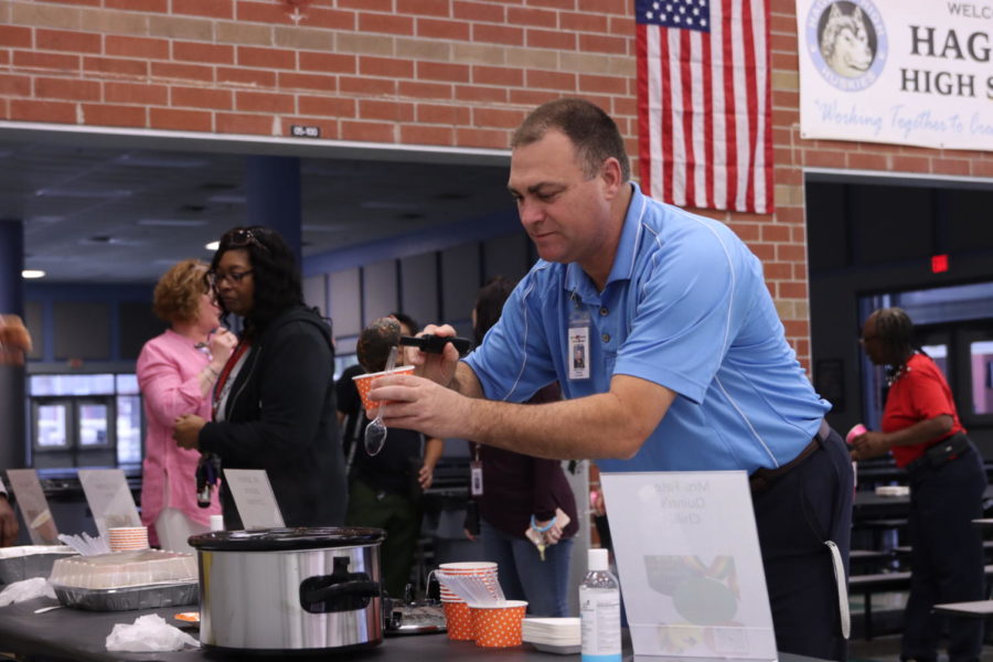 Principal Robert Frasca serves himself some of Dean Kelly Fate-Quinns cowboy chili. Fate-Quinns chili took first place in the chili category. 