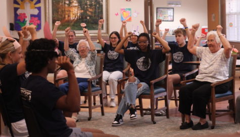 NHS members Sid Rajan, Mia Campese, and Aryan Patel host a group exercise glass for Lutheran Haven residents along with numerous NHS members who took part in the class. 
