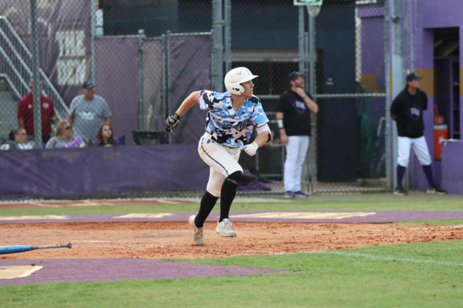 Junior Austin Jacobs is running to first base. Jacobs hit a home run in the semifinal game, helping advance the team to the championship. 