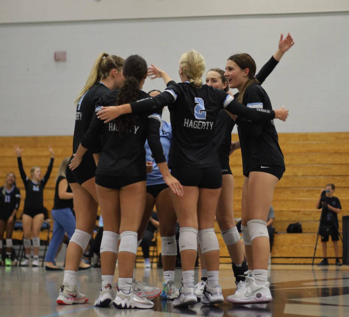 The+girls+varsity+volleyball+team+celebrates+after+a+kill+against+Lyman+on+Aug.+23.+Hagerty+won+3-0%2C+starting+a+winning+streak+for+the+upcoming+season.