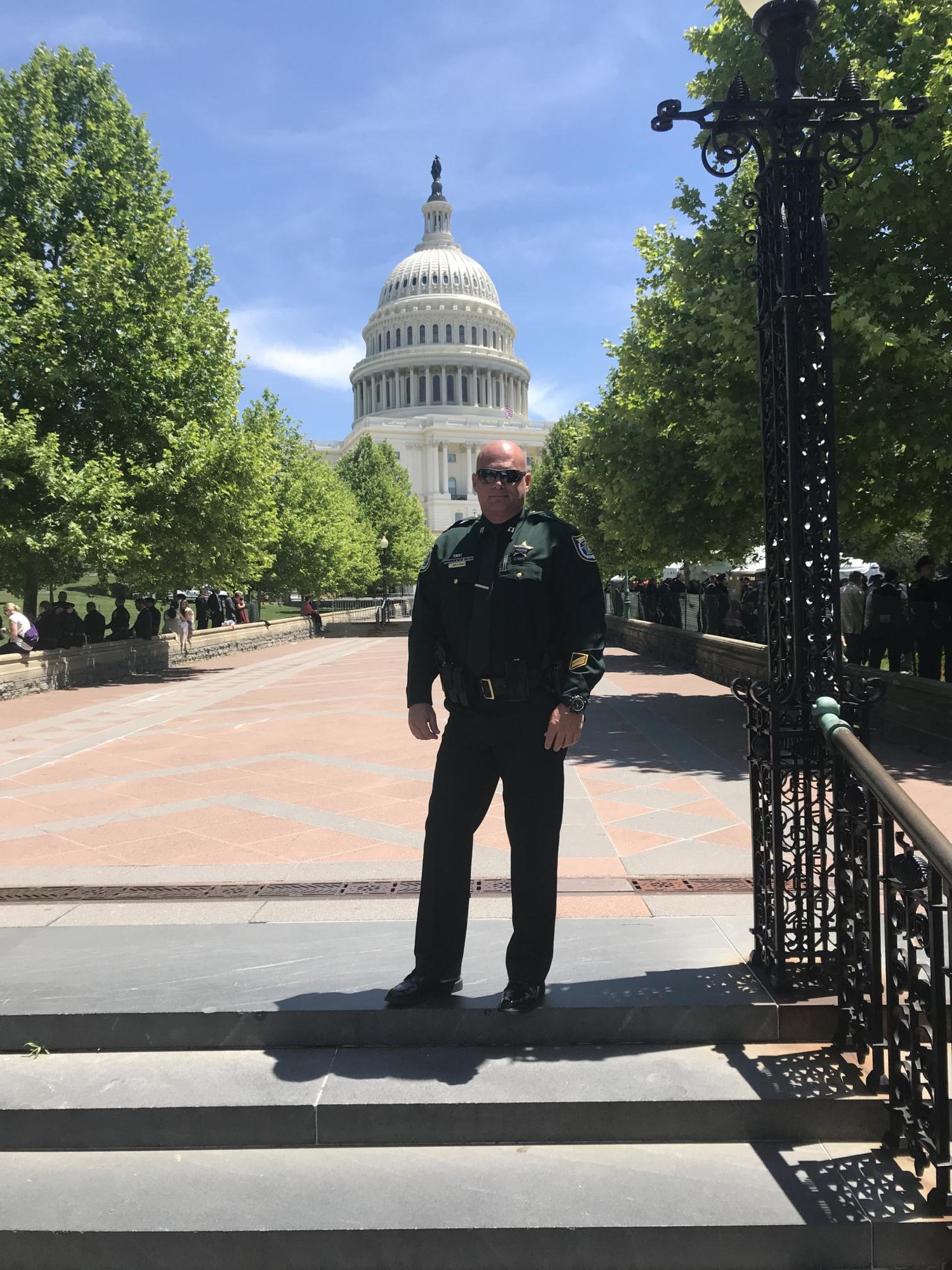 Chief Francis poses in front of the Capitol building. Many jobs and positions were only available to him because he pursued a degree in college.