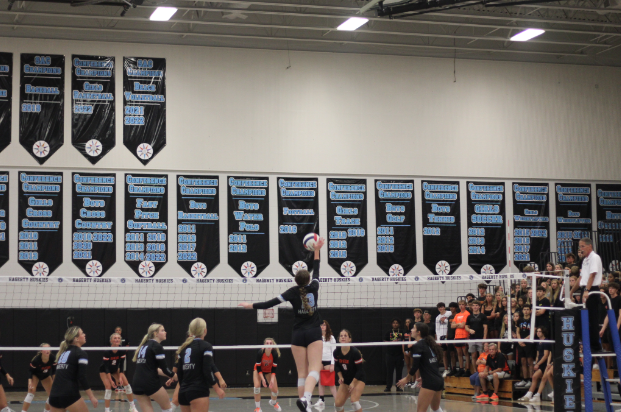 Outside hitter Faith Walsh goes for the kill. The girls varsity volleyball team won against Oviedo 3-0.