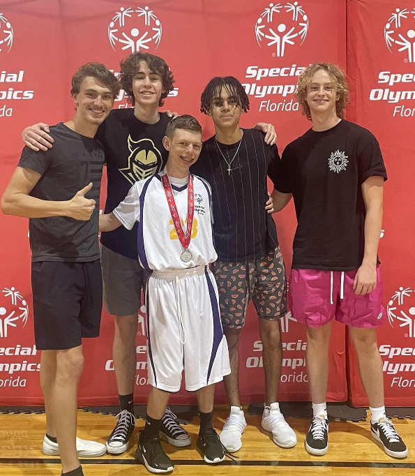 Will Seavers and friends after he received his medal at the Special Olympics. After discovering a love for basketball, Will began to compete for his middle school team and participate in the Special Olympics games.