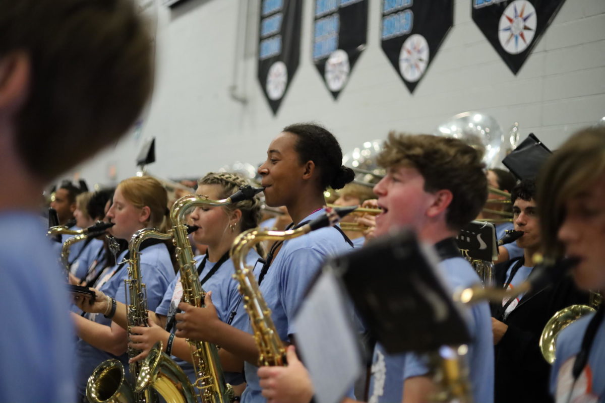 Junior Arianna Maboudou-Tchao plays her saxophone during the pep rally. The band was able to showcase pieces from their current half-time show, Space Odyssey, during the event.