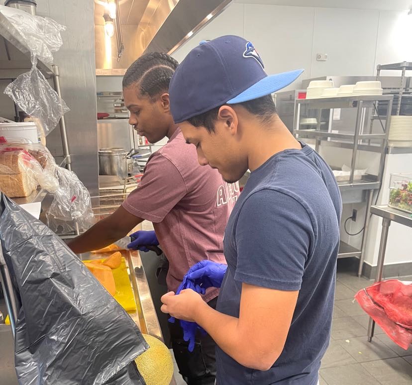 Junior Alton Ashford prepares food for the residents of Benton House.  During his volunteering shift, Ashford prepares food, organizes events, and serves the elderly.