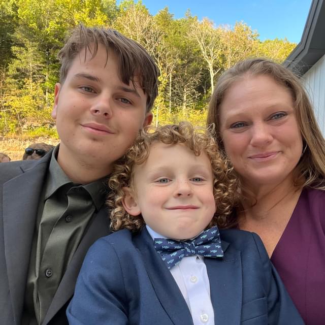 Junior Brycen Dillinger smiles with his younger brother, Lincoln, and his mom, Tracy, by his side. Community support was essential for Dillingers recovery. 