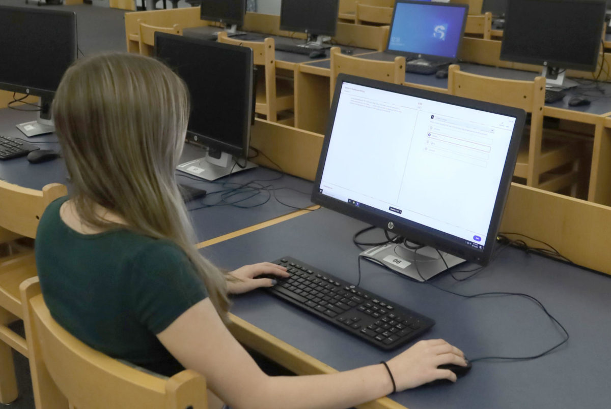 Junior Faith Johnston takes practice SAT questions in preparation for the new digital version of the test. In spring 2024, the SAT will effectively be switched from a paper and pencil test to digital.