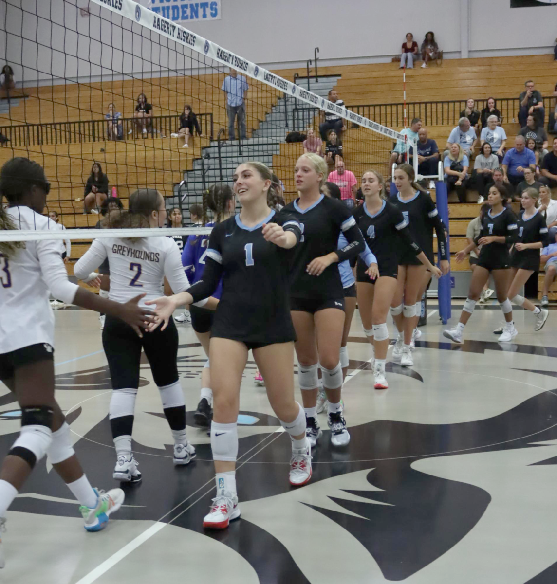 The team gives Lyman handshakes before the game starts. Hagerty won the match with a clean sweep, 3-0.