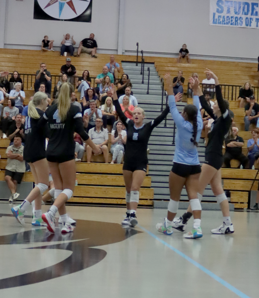 The team celebrates after getting the point. Hagerty won the third match 25-13.