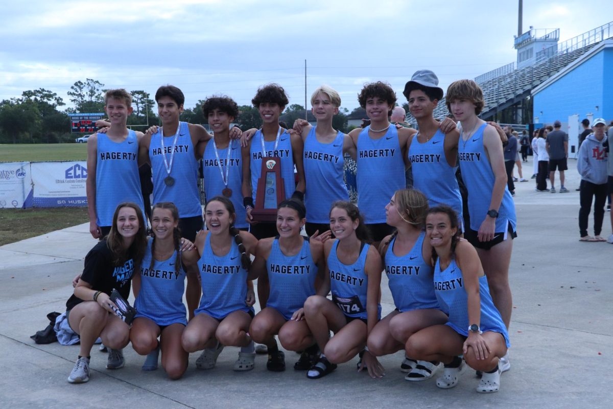 The+Boys+and+girls+team+pose+for+a+group+photo+after+districts.+Johnathon+Leon+%28middle%29+holds+a+trophy+and+a+first+place+medal.+