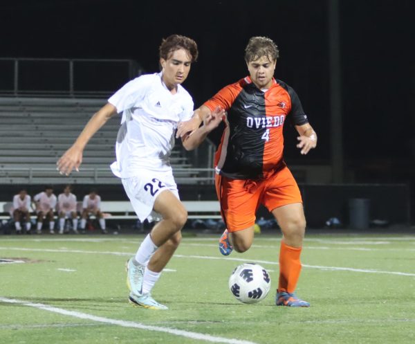 Forward Sebastian Rubio fights Oviedo's defense for the ball. The boys varsity soccer team tied with Oviedo 2-2.