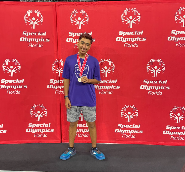 Junior Bassel Abualsamid shows off his Special Olympics gold medal. Bassel recently earned gold for pickleball at the games.