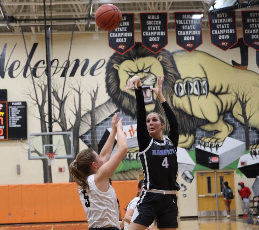 Forward Kylee Pitts shoots and makes a contested shot over an Oviedo player increasing the huskies lead.