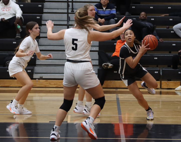 Guard Ciara Hayes drives along the baseline. Three Oviedo players close in.