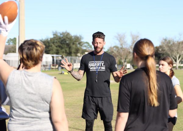 Head coach David Attaway explains the next drill to the girls at tryouts. Focusing on the basics of the game, Attaway must teach the team proper plays and strategies before their game against Oviedo on Feb. 20.