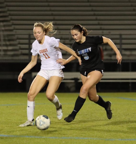 Attacking midfielder Megan ODonnell boxes out her opponent for the ball. The girls soccer team won against Atlantic Coast 2-1.
