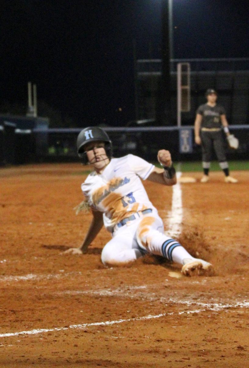 Freshman Alina Gallagher slides into home base. 