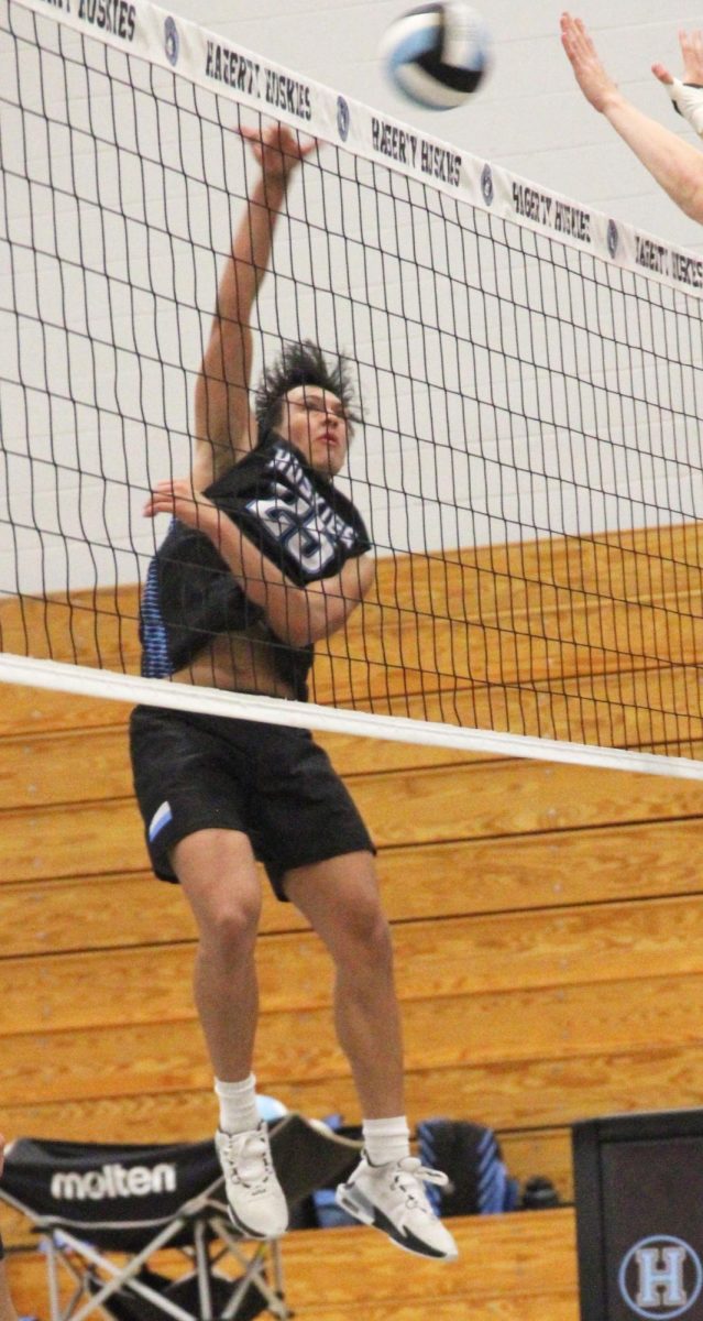 Senior Marcel Clemens spikes the ball over the net. Clemens has been on the varsity team for three years. “The best way to improve is to stay consistent with your practice,” Clemens said. “Also, teamwork… the closer you become with your teammates the better you will work together.”