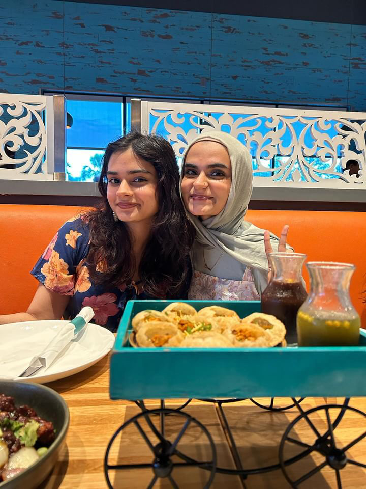 Senior Zahra Ateeq and her sister snap a quick picture before eating chaat, a common south Asian snack. Growing up in a white-dominated school, Ateeq struggled to be proud of her Pakistani heritage and food throughout her earlier years. 