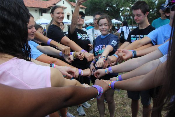 Members of Best Buddies and Fashion Club celebrate with handmade bracelets before the beginning of the Friendship Walk. This event brought together Best Buddies clubs from all over Central Florida.