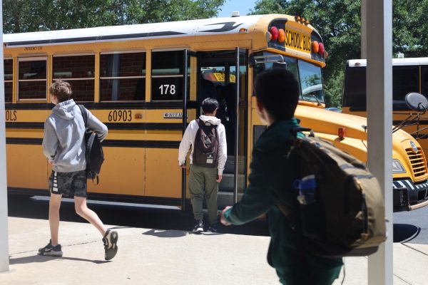 Students board the bus at the end of the school day. In the first week of April, Hagerty started requiring students to scan themselves on and off the bus using IDs distributed the week before.