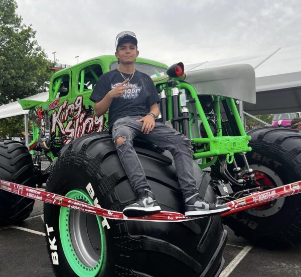 Junior Sebastian Acosta poses with monster truck “King Sling” at the 2023 World Final Pit Party. Pit Parties are one of the main features of Monster Jam competitions apart from the show. The event lasts around five hours and fans get to interact with drivers and pose with the Monster Truck of their liking.
