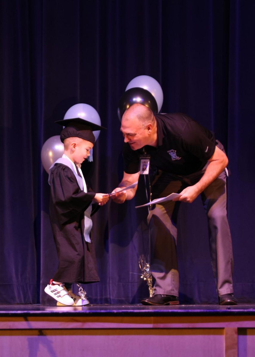 Principal Robert Frasca handing out diplomas to the Husky Pup Preschool graduating class. He has taken time each year to celebrate the students on their accomplishment during his high school duties. It is a bright spot in my day because theyre just so cute, Frasca said. You always try as much as you can to find an hour to be a part of stuff like that, because its fun.