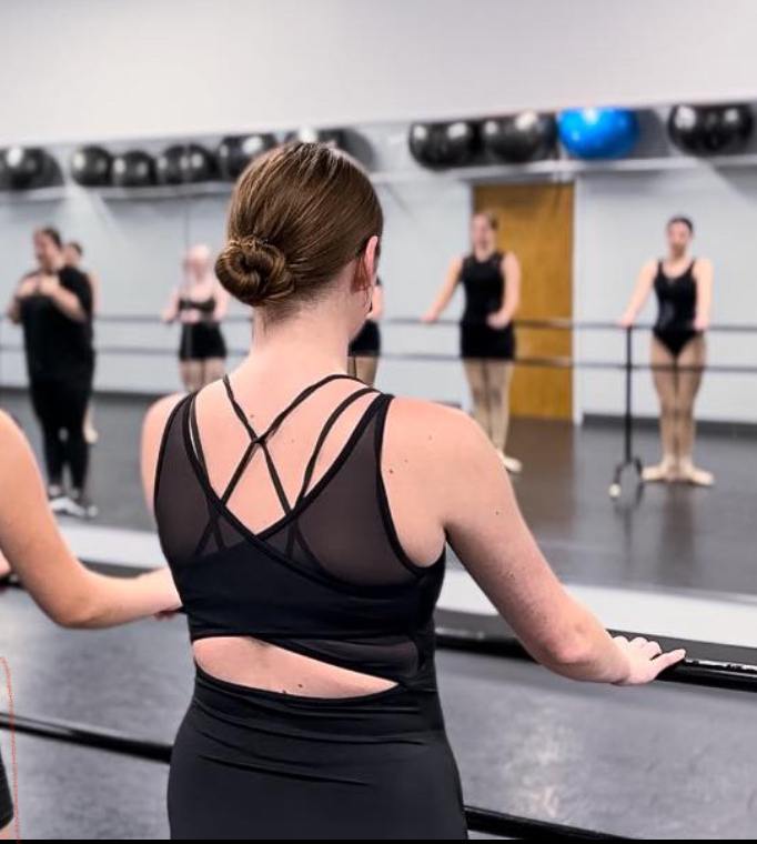 Sanguinetti practices at bar to warm up for her pointe class. Common moves such as pliés, tendus and adagio are used to help get dancers prepared for class.