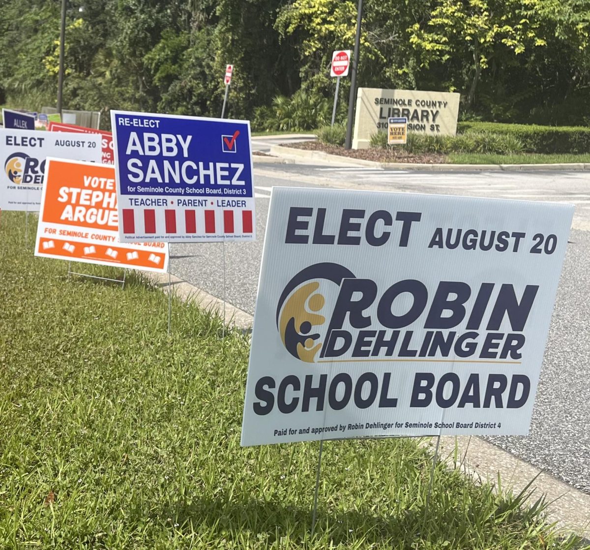 Campaign signs for Robin Dehlinger, Abby Sanchez and Stephanie Arguello sit outside of the Seminole County Public Library's Oviedo Branch, one of the polling locations for the August elections. Few people take the time to vote in smaller, local elections, leading to a voter turnout of only 17.7 percent.