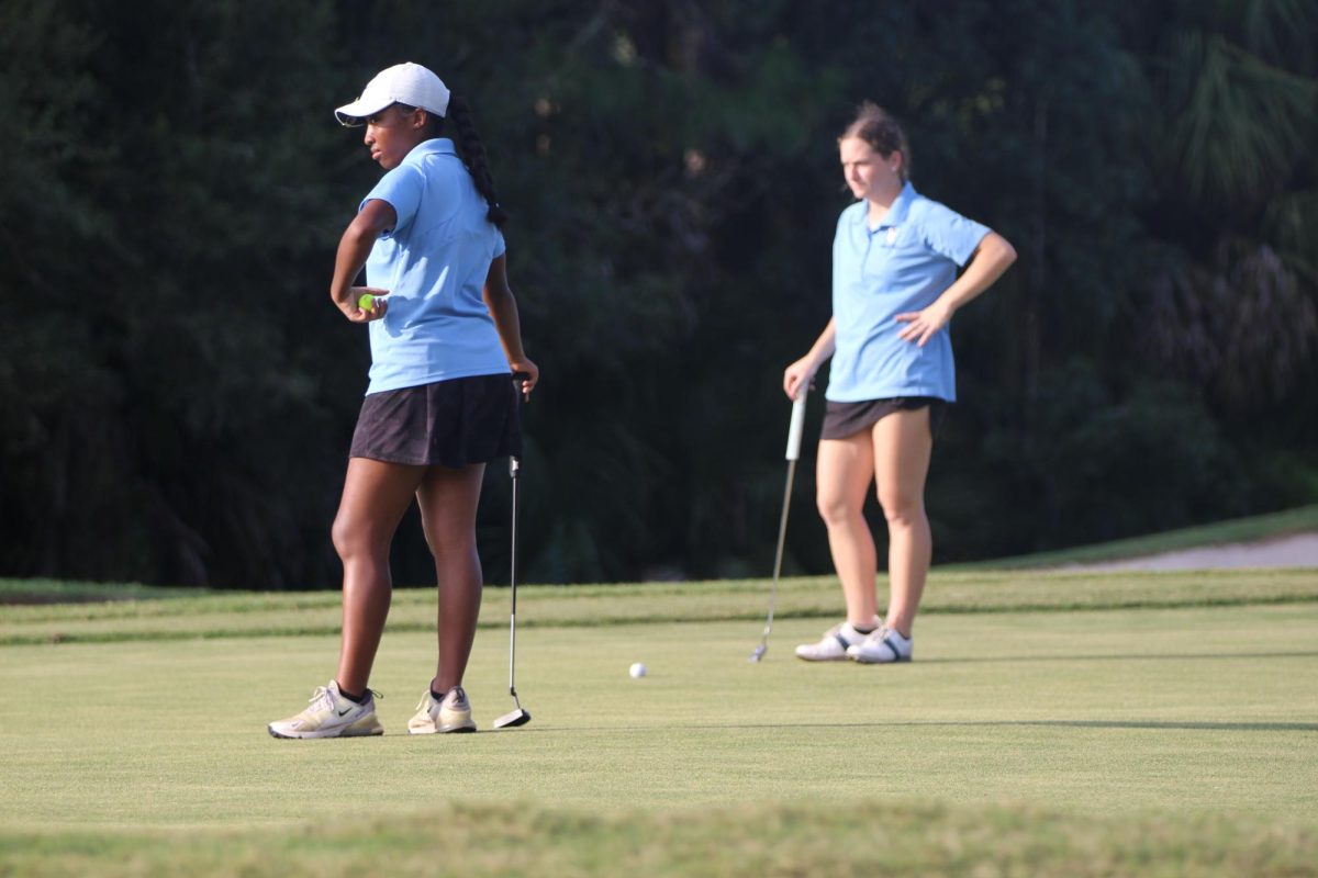 Isla Saint-Jean and Emma Roberts watch Lake Brantley hit. Saint-Jean and Roberts were partners in the 188-188 tie.