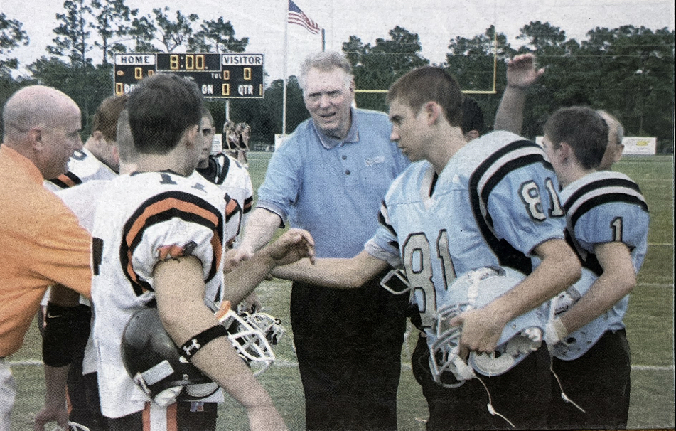 Football players from Oviedo and Hagerty shake hands with superintendent Paul J Hagerty before the first rivalry game. The rivalry games between these two schools have become major events in the community. 