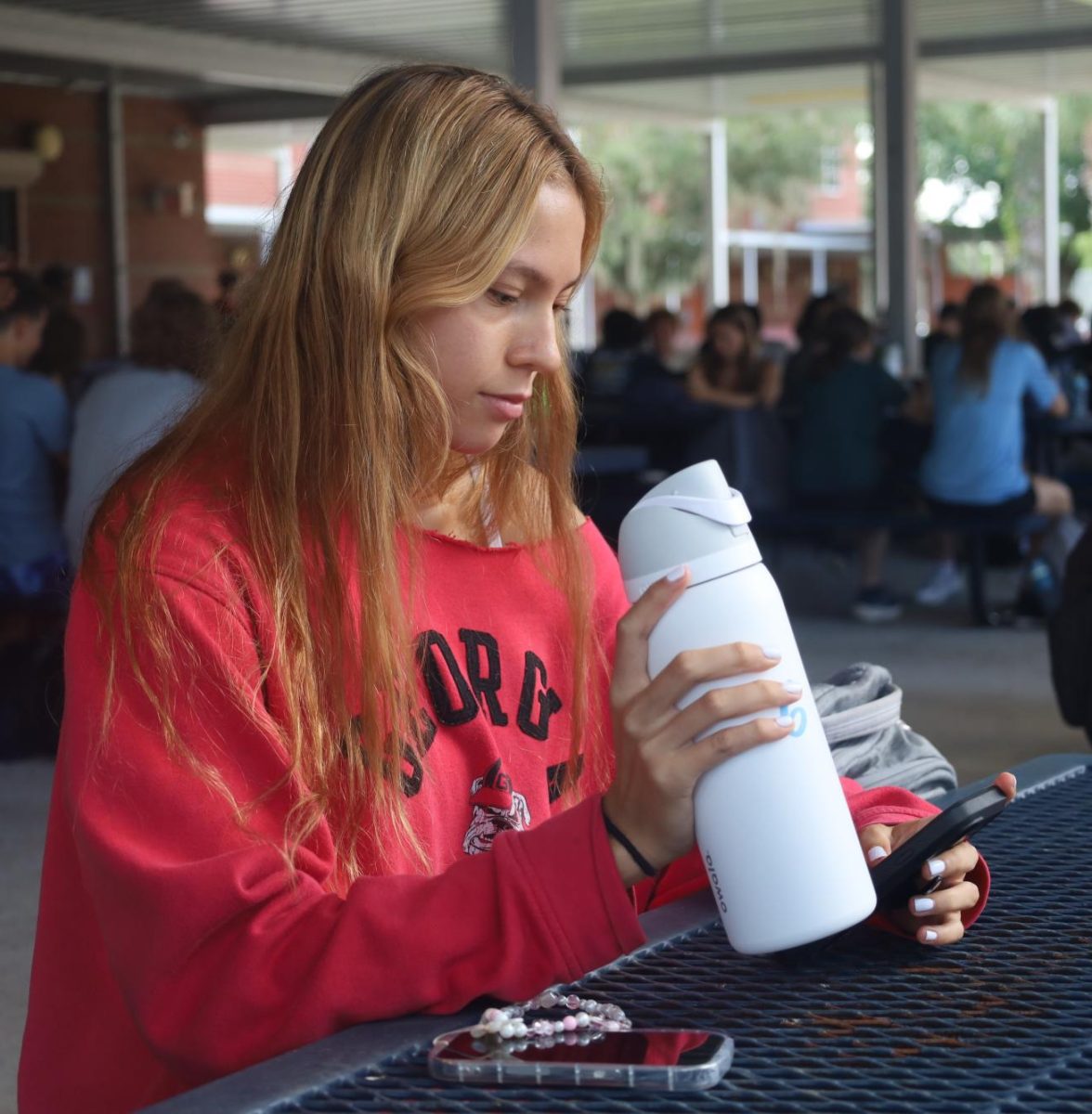 Senior Dakota Pacheco sips from her Owala Free Sip water bottle. Many students purchased an Owala before the school year, as their trendy design and funky color combinations made them rise in popularity.