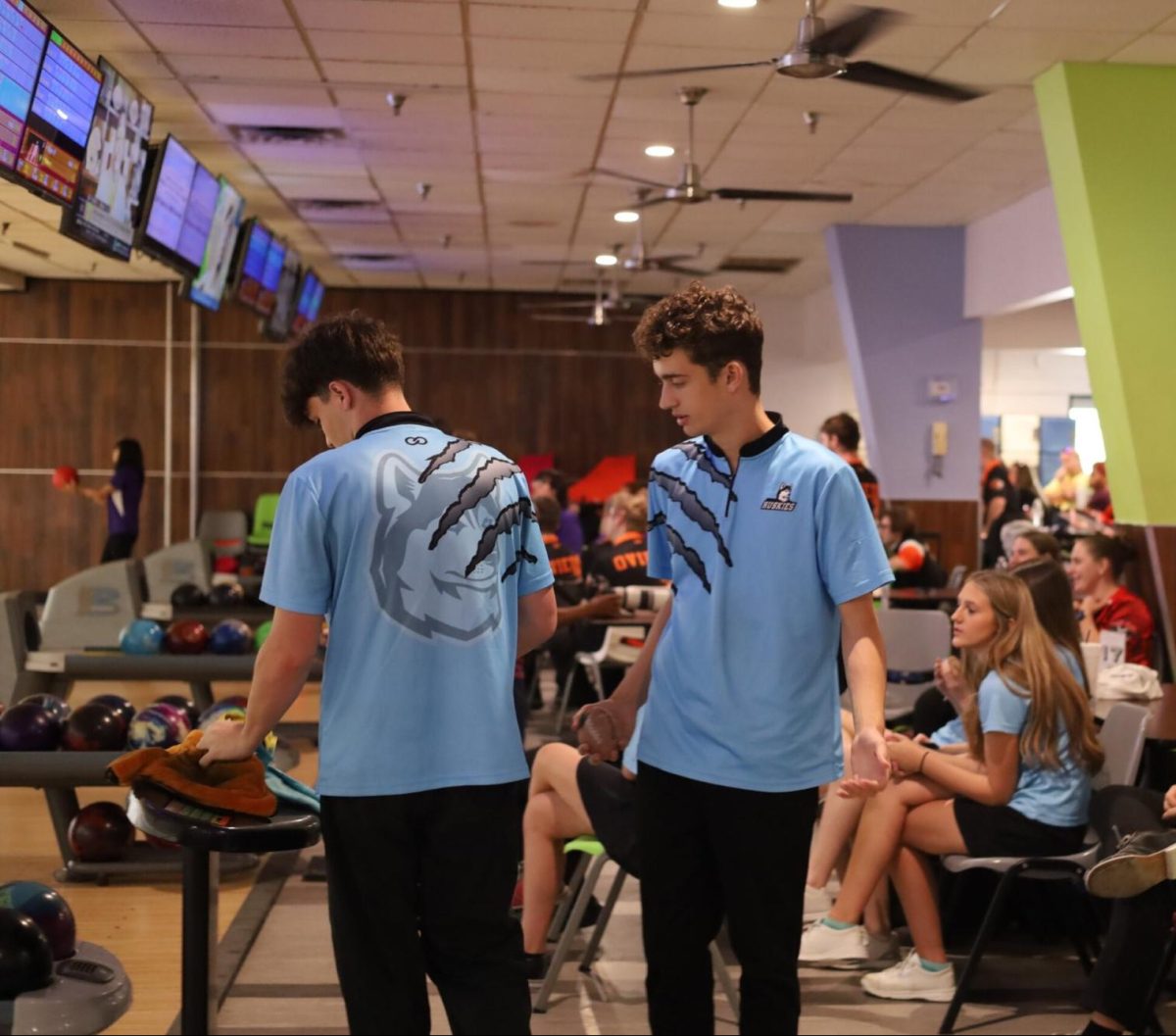 Junior Noah McPherson walks back toward his seat after playing a frame. With 312 total pins, McPherson contributed to the team's success on Wednesday.