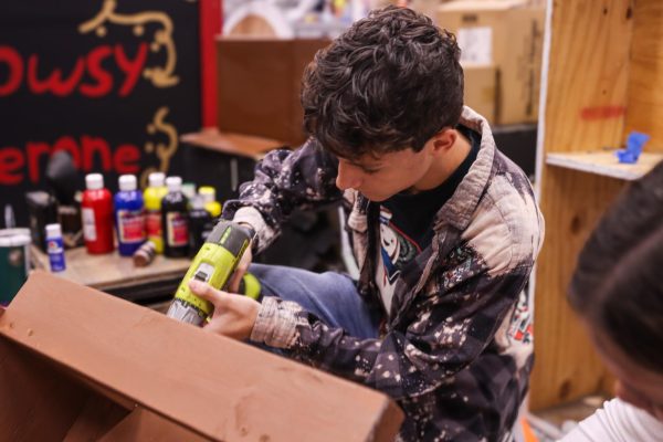 Senior Cole Jones works on a set piece for the drama department's production of "Percy Jackson: The Lightning Thief." The musical will run from Oct. 17-19. 