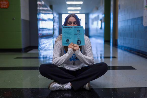 Student Government Association member Celine Merlin, poses with her homecoming playbook. Homecoming week will begin from Oct. 21 through Oct. 25.