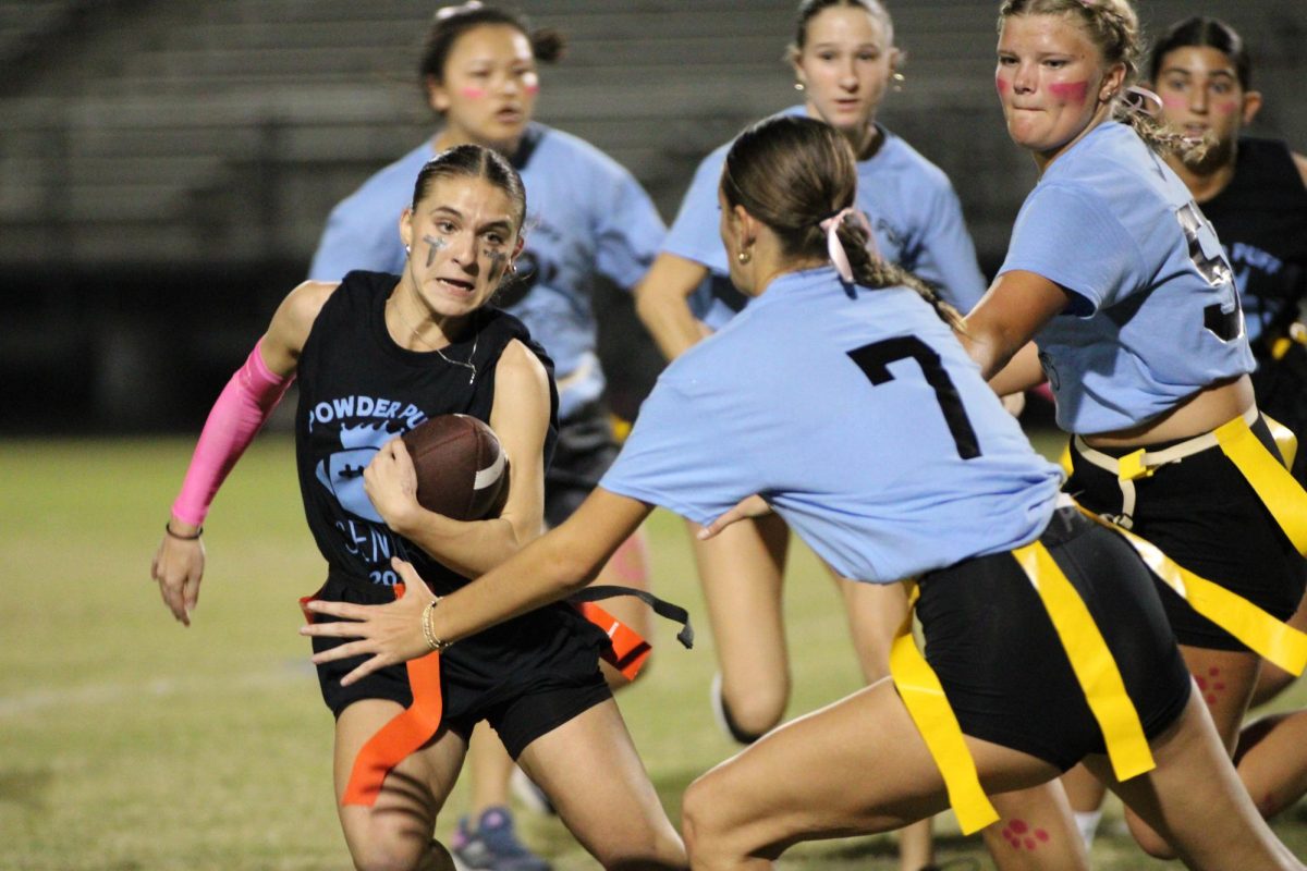 Senior Gia Digiore swerves to avoid the junior defender. The seniors beat the juniors 30-0 Tuesday night.  