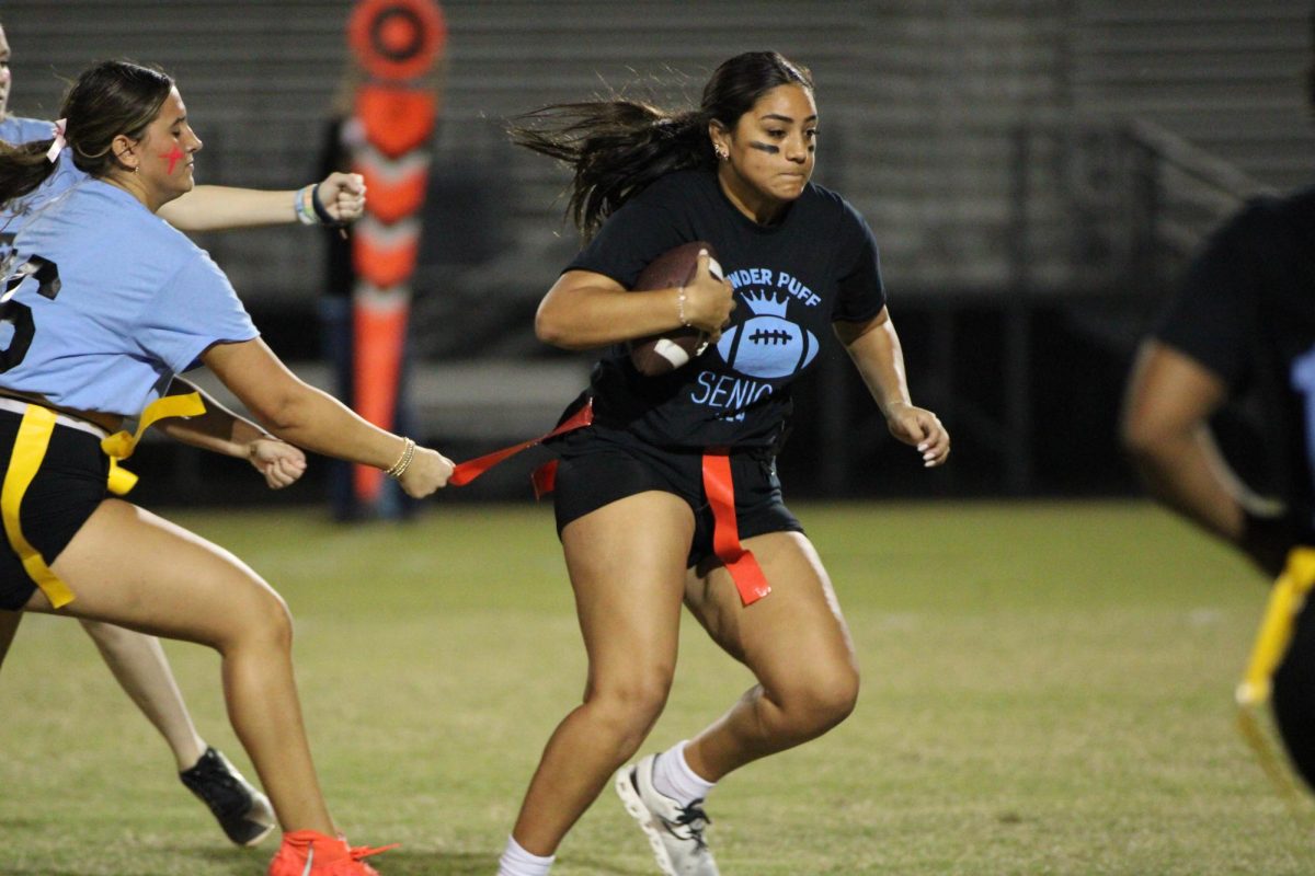 During Tuesday's powderpuff game, senior Gabby Diaz runs down the field as her flag is being pulled. 