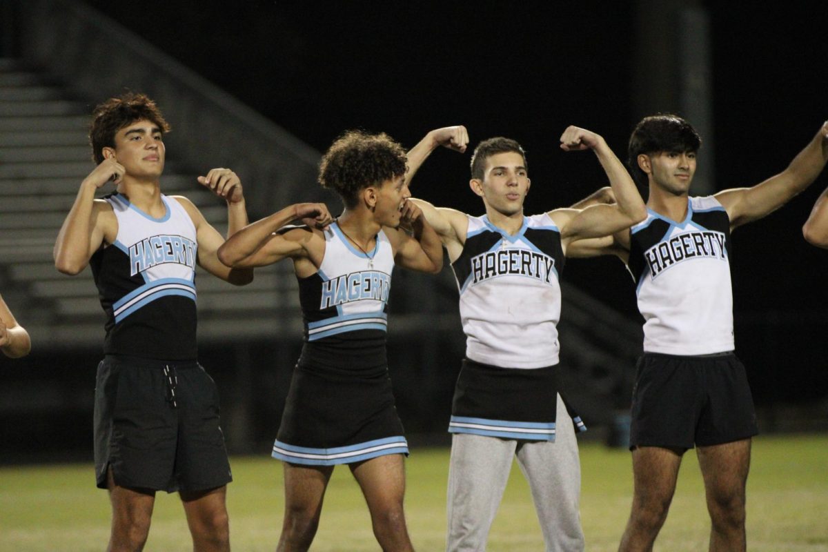 Sebastian Rubio, Brian Buster, Zachary Zampella and Sergio Portillo-Rivera flex with the senior cheerleading team. The senior team practiced twice before Tuesday's event. 